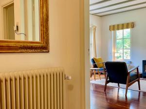 a living room with a radiator and a mirror at Gastenhuis Deurnink in Vorden