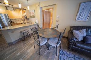 a living room with a table and chairs and a couch at Silver Mill 8228 by SummitCove Lodging in Colorado in Keystone