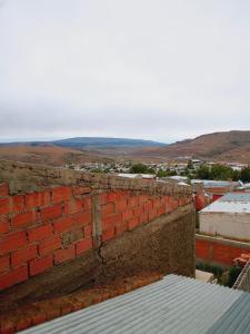 a brick wall on top of a building at Departamento Los Ñires in Yacimiento Río Turbio