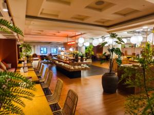 a lobby of a restaurant with chairs and plants at Fosen Hotel in Taichung