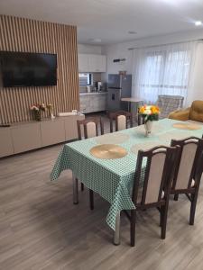 a kitchen with a table and chairs and a kitchen with at Casa Mara in Ideciu de Jos +9 photos