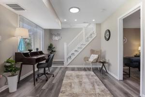 a living room with a piano and a staircase at Spacious 5 Bed 2 bath House in Melrose Park