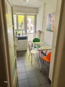 a kitchen with a table and a table and chairs at YveSkinYoga in Zurich