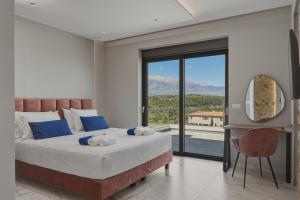 a bedroom with a large bed with a large window at Moon and Sun in Vamos