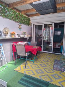 a room with a table and chairs on a patio at Le Passager Cilaos maison privée in Cilaos