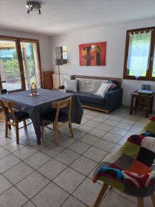 a living room with a table and a couch at Gite La Baraque in Najac