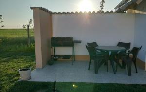 a patio with a table and chairs and a fence at Wild Serenity in Vadu