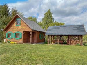 a house with a gazebo in a yard at Holiday House Folwark Jeleń in Poniklica