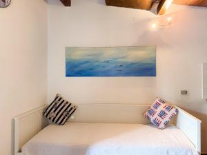 a bed in a room with a painting on the wall at Fuga d'Amore - HelloElba in Portoferraio +12 photos