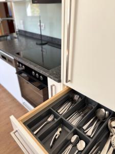 a drawer in a kitchen with utensils in it at Ferienwohnung Am Pillersee in Sankt Ulrich am Pillersee +16 photos