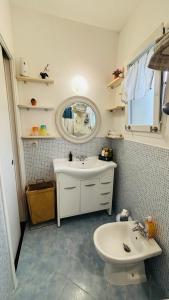 a bathroom with a sink and a toilet and a mirror at La Casa di Trilli in Moneglia +32 photos