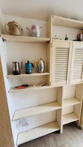 a shelf in a kitchen with pots and pans at La Casa di Trilli in Moneglia