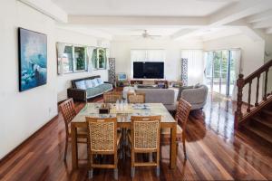 a living room with a table and chairs at Green Ocean Kingdom House in Uruma