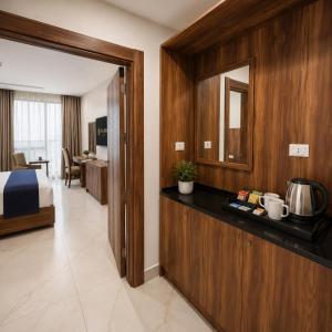 a hotel room with a bed and a counter with a sink at Ten Hills Hotel in Amman