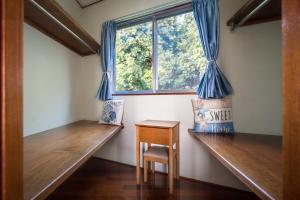 a room with two wooden benches and a window at Green Ocean Kingdom House in Uruma