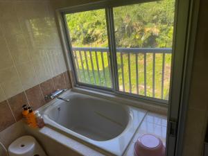 a bath tub in a bathroom with a window at Green Ocean Kingdom House in Uruma +64 photos