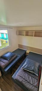 a bedroom with two beds and a window at Camping l'Or Bleu in Barrême +12 photos
