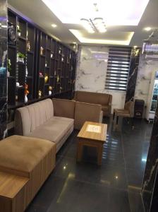 a living room with a couch and a coffee table at Hazie Hotel in Lagos +2 photos