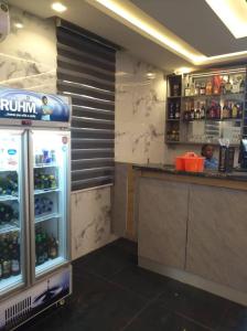 a drink bar in a restaurant with a refridgerator at Hazie Hotel in Lagos