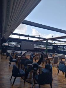 a patio with chairs and tables and aokedokedoked at Hazie Hotel in Lagos