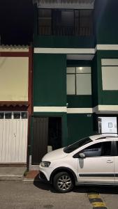 a white car parked in front of a building at APARTAMENTO cerca al UNICO in La Victoria