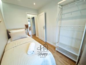 a bedroom with a bed and a glass shower at Happy Deluxe ApartamentyHappy pl in Mielec