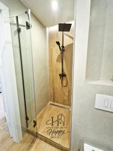 a shower with a glass door in a bathroom at Happy Deluxe ApartamentyHappy pl in Mielec