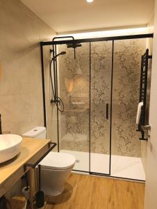 a bathroom with a shower with a toilet and a sink at Iguzki Etxea in Urzainqui