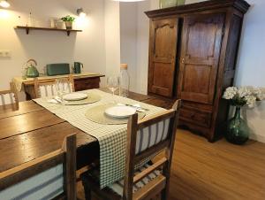 a dining room with a table with plates and wine glasses at Iguzki Etxea in Urzainqui +9 photos