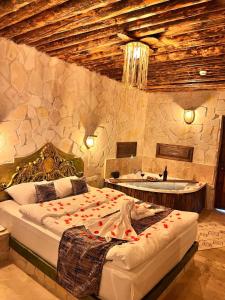 a bedroom with a bed and a tub and a sink at MMF cave house in Nevşehir