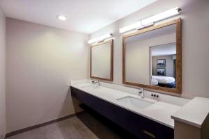 a bathroom with two sinks and a large mirror at Cape Cod Family Resort and Parks in West Yarmouth