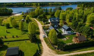 an aerial view of a house with a lake at Oaza Radęcin in Woldenberg Neumark