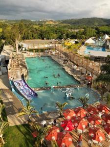 a water park with people swimming in a pool at Chalés - Aquabeat in Sao Jose da Lapa +11 photos