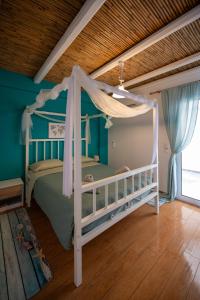 a bedroom with a bed with a canopy at Kalypso Rental Apartment in Myloi