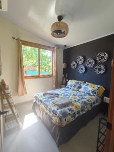 a bedroom with a bed and plates on the wall at Caribbean Lory in Puerto Viejo +13 photos