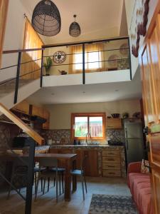 a kitchen with a spiral staircase in a house at Caribbean Lory in Puerto Viejo