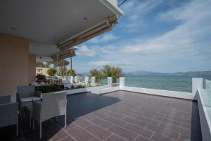an outdoor patio with a view of the water at Kalypso Rental Apartment in Myloi
