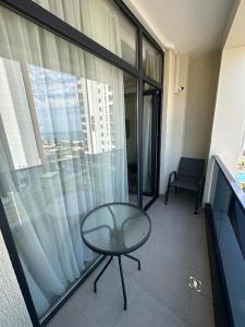 a room with a glass table and a window at Green side in Kvariati
