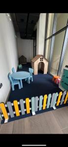 a room with a table and a dog house at Green side in Kvariati +2 photos