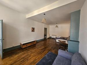 a living room with a couch and a table at Private Apartment in Rochechouart