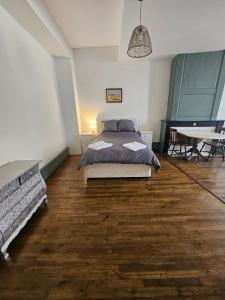 a bedroom with a bed and a table in it at Private Apartment in Rochechouart