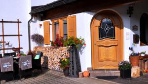 a building with a door and a table with flowers at Gästehäuser Schwemmbauer in Reit im Winkl
