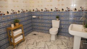 a bathroom with a toilet and a sink at Quiet Mini Villa with Garden in Luxor