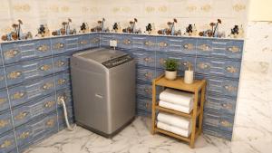 a trash can in a bathroom with blue tiles at Quiet Mini Villa with Garden in Luxor