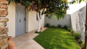 a garden with a door and a grass yard at Quiet Mini Villa with Garden in Luxor