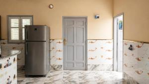 a kitchen with a refrigerator in a room at Quiet Mini Villa with Garden in Luxor