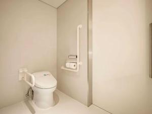 a bathroom with a toilet and a shower stall at Hotel Grand Tela Suite Delhi in Gurgaon