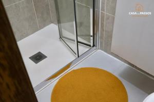 a shower with a yellow stool in a bathroom at Casa dos Passos 1 in Guarda +33 photos