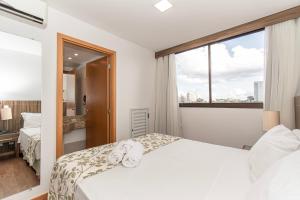 a hotel room with two beds and a window at Nobile Hotel em Brasília 97172 in Brasília