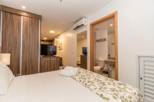 a bedroom with a large white bed and a bathroom at Nobile Hotel em Brasília 97172 in Brasília +38 photos